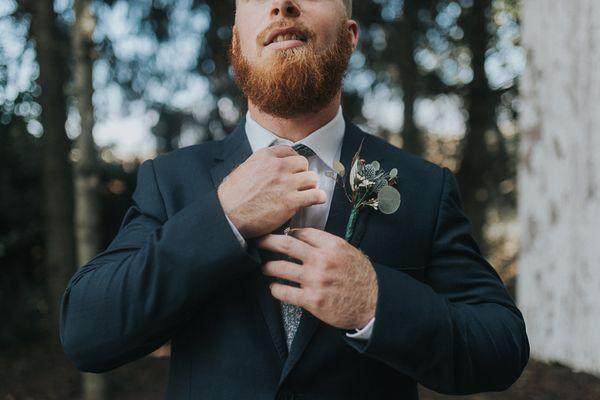 Groom fixing his tie