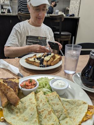 Cheese enchiladas and French toast with blueberries and bananas