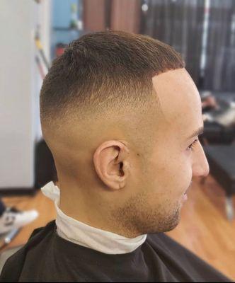 Mid skin fade with a textured scissor cut