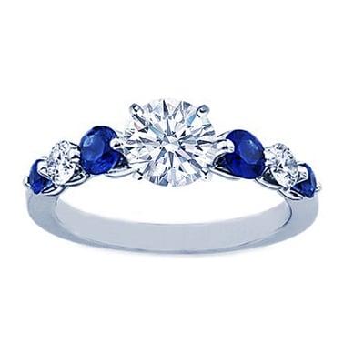 Unique round cut diamond engagement ring with blue sapphire stones by Classic Diamond House!