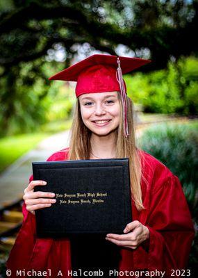 Graduate holding her diploma.