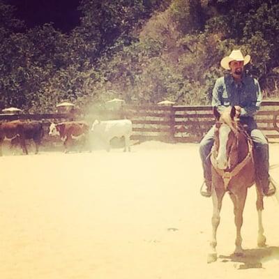 Uncle Jake riding Western with our cows