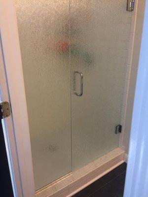 Shower door with waterfall privacy glass.