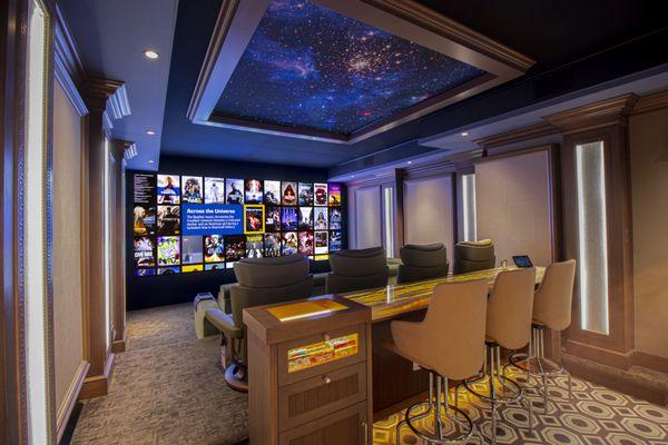 Experience our upgraded reference theater with a bigger screen, enhanced audio, new seating, a bar, and a new projector.