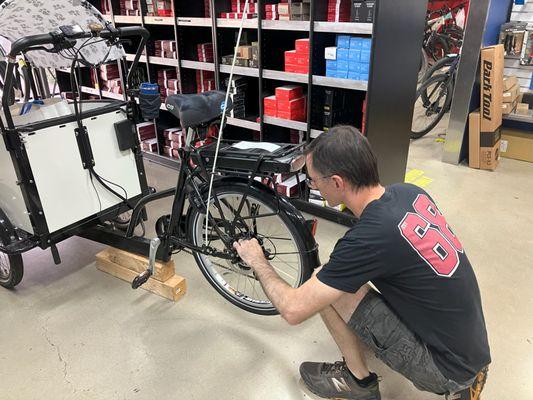 Mechanic Dillon replacing defective wheel on a Bunch Cargo Bike.