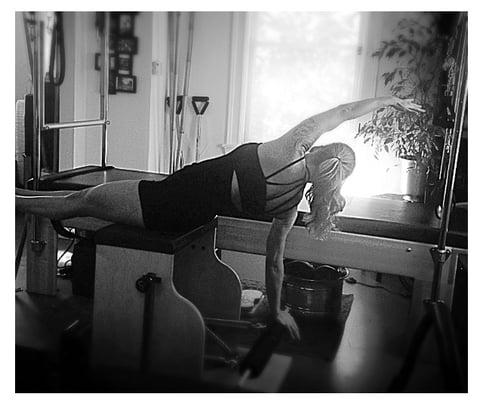 Reverse swan with twist on the Pilates Wunda chair Pilates exercise at Body, Root & Soul