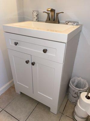 New bathroom vanity that needed to be installed with some sheet rock repairs to the wall that sits behind it.