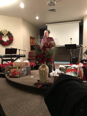 Pastor's wife saying a few words at ladies tea brunch