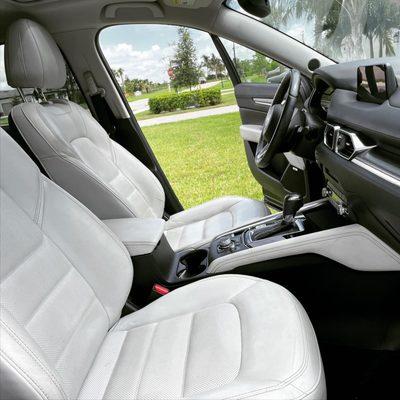 White leather interior cleaned and conditioned with streak free interior, UV protection.