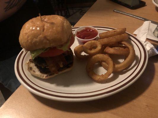 Double cheeseburger with bacon and onion rings on the side. The bread is the best too!