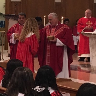 His Eminence Bishop Neil T giving Communion