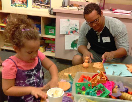 A father and daughter making play dough creations at Fathers' Night!