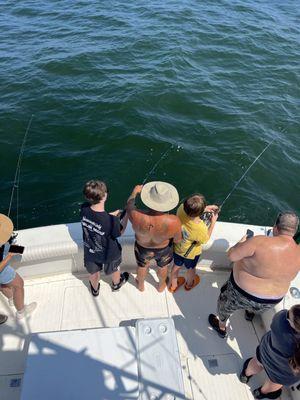 The mate helping the young guys fish