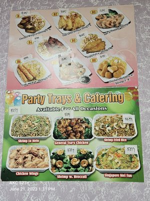 Wall menu of catering party tray options.