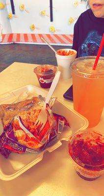 Melon water, tostielote, corn in a cup, and gummies with chamoy and chili powder.