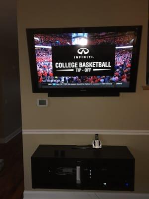 50" television installation with soundbar and media center.