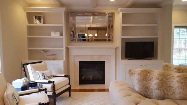 We removed the dividing wall between formal living room and family room, added columns with built ins, and constructed coffered ceilings.