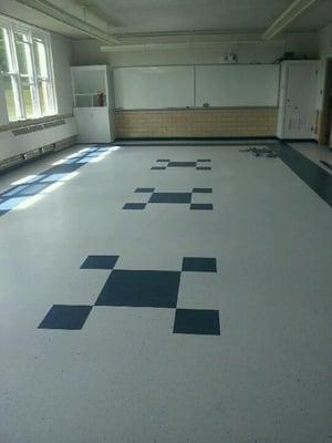 VCT tile installation in a classroom shown before waxing