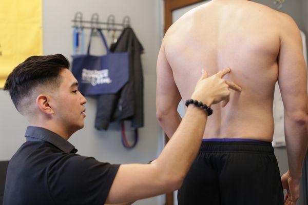 Dr. John performing a static alignment exam during a full body movement evaluation. Holistic examination leads to the best results!