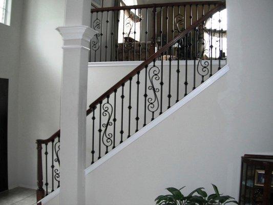 Over the post railing with iron balusters.