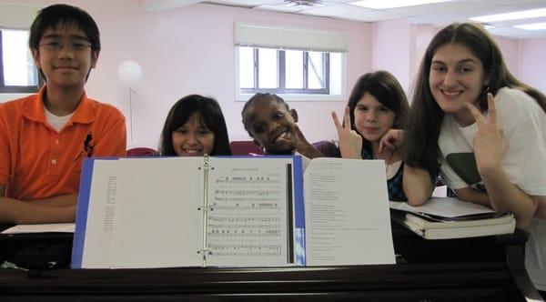 Drama class rehearsing around the piano