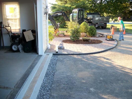 Proper installation of "poly drain" drainage product in front of a garage.