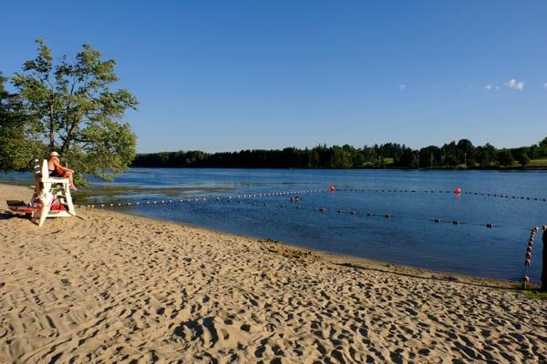 Beach area at the Rudd Pond with life guard on duty.