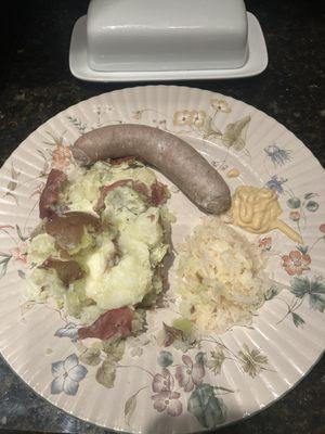 Bratwurst, sauerkraut, red potatoes, and Hellman's mustard