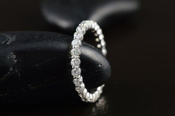 Shared prong diamond eternity band in white gold.