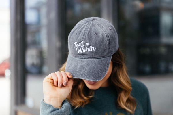 Woman holding Fort Worth hat