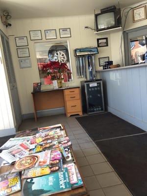 Small but comfortable waiting area with conplimentary beverages for waiting customers.