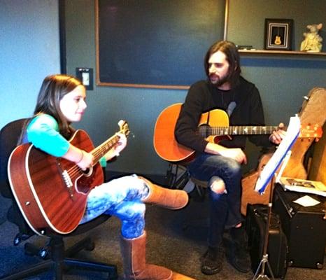 Erin Burke-Moran teaching guitar.