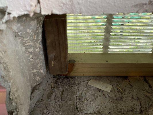 Inside garage of framed temporary vent and new concrete block