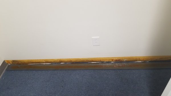 One of many pics where ALL of our baseboards had fallen down. The glue was still wet.