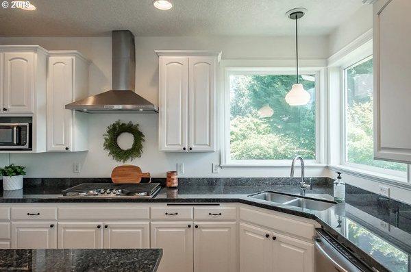 Painted existing cabinets, new gas cooktop, sink and lighting