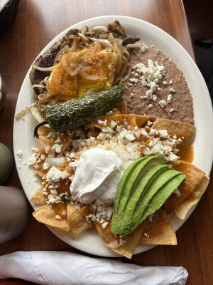 Chilaquiles rojo with steak and eggs very delicious