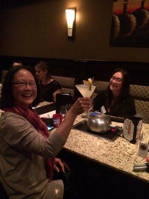 Shal and Kristen getting comfortable with big smiles at Melting Pot!