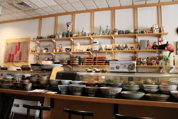 Stacks of plates and decor within their sushi bar