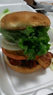 Burger with bacon, lettuce, tomato, onions