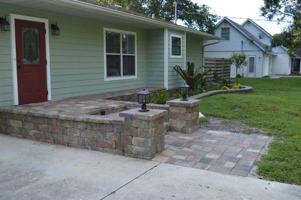 Front entryway with ledger stone and planter wall.