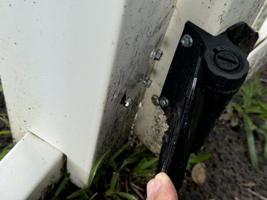 Broken gate hinge from being bumped by heavy mower