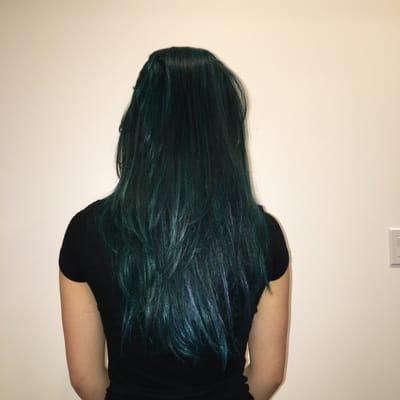 Teal and blue. This is brighter in person but you can see the different colors mixed in with her natural black hair.