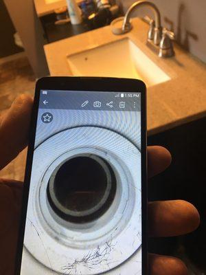 Jason's employee's phone showing Proof that master shower unaligned causing leak underneath and around tub shower into closet