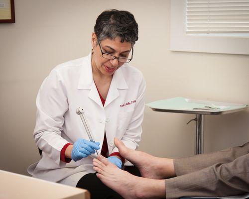 Dr. Pardis Kelly examining a patient