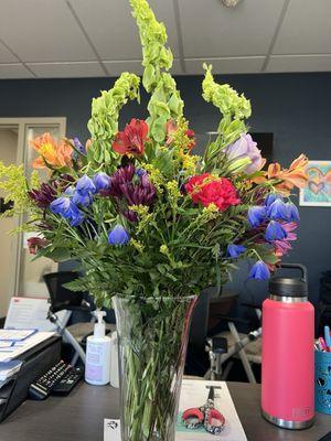 The back of the arrangement. Was this a funeral arrangement because why is the back bare?