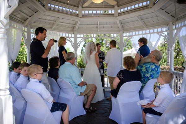 White on white...unique wedding ceremony under the gazebo with family & friends.