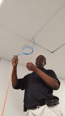 Technician running ethernet cable for Wi-Fi setup