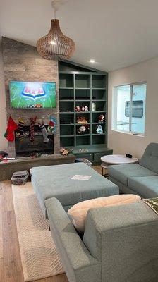 The living room, with custom couch, and wooden cage light fixture