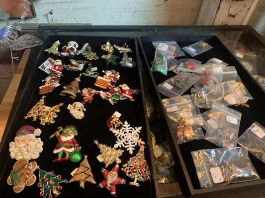 A vast array of Christmas brooches/pins.