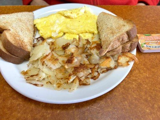 Scrambled eggs, home fries and toast, senior size.